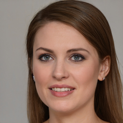 Joyful white young-adult female with long  brown hair and grey eyes