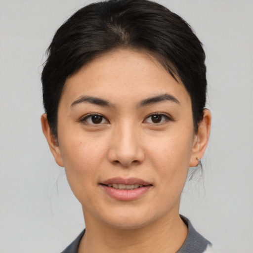 Joyful asian young-adult female with short  black hair and brown eyes