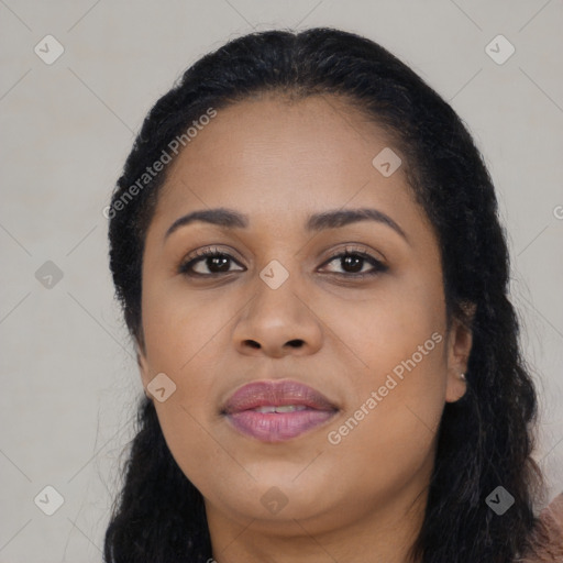 Joyful black young-adult female with long  black hair and brown eyes