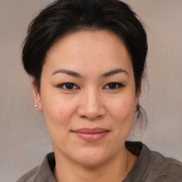 Joyful white adult female with medium  brown hair and brown eyes