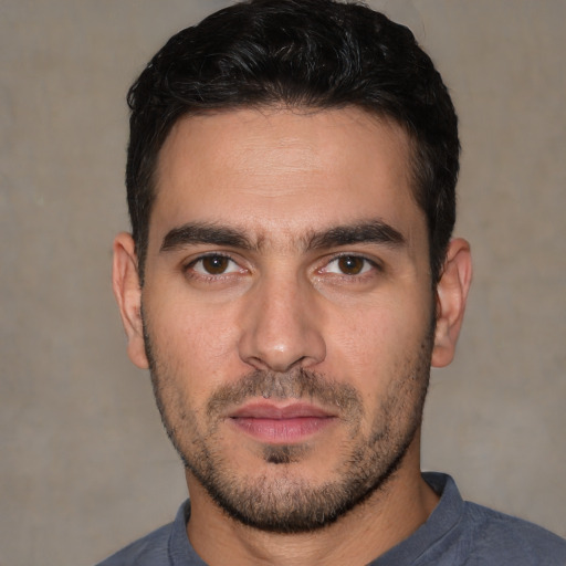Joyful white young-adult male with short  black hair and brown eyes
