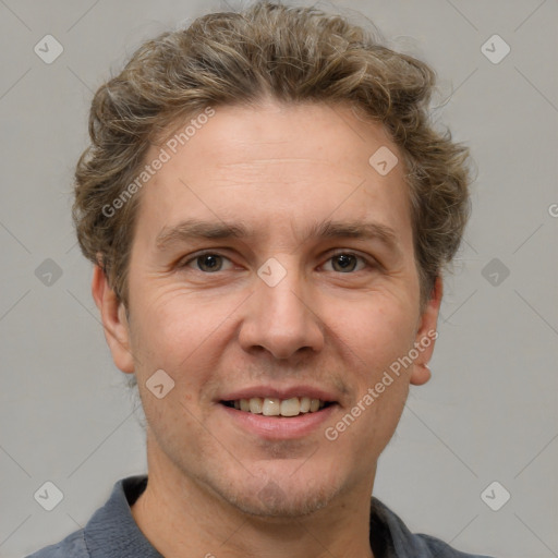 Joyful white adult male with short  brown hair and grey eyes