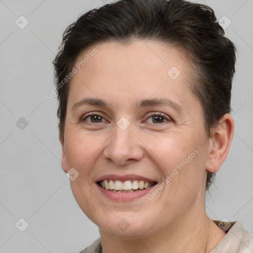 Joyful white adult female with short  brown hair and brown eyes