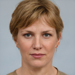 Joyful white adult female with medium  brown hair and grey eyes