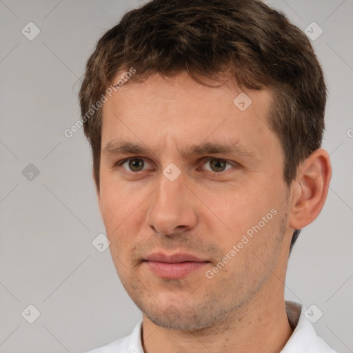 Joyful white adult male with short  brown hair and brown eyes