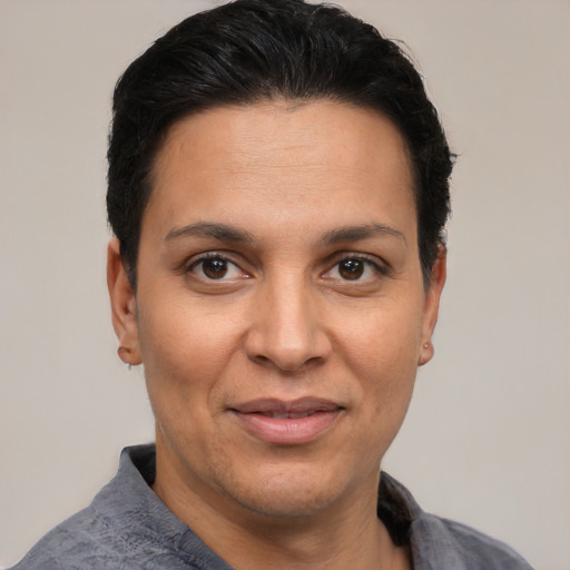 Joyful latino adult female with short  black hair and brown eyes