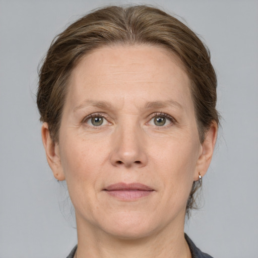 Joyful white adult female with medium  brown hair and grey eyes