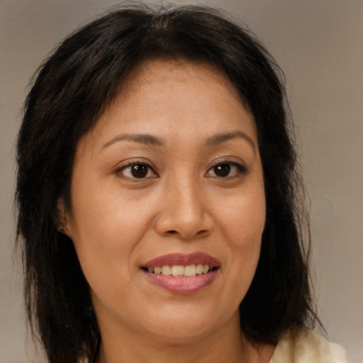 Joyful asian adult female with medium  brown hair and brown eyes