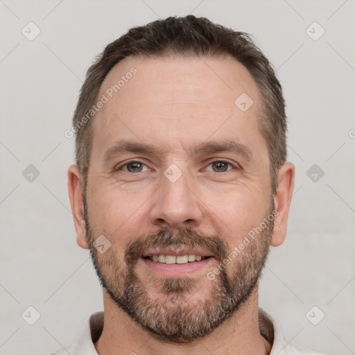 Joyful white adult male with short  brown hair and brown eyes