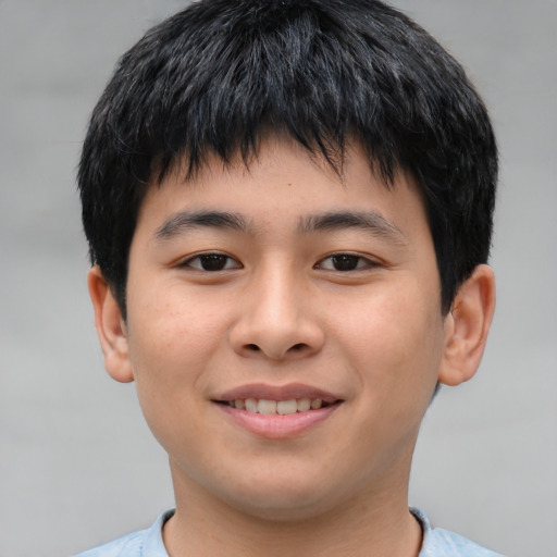 Joyful asian child male with short  brown hair and brown eyes