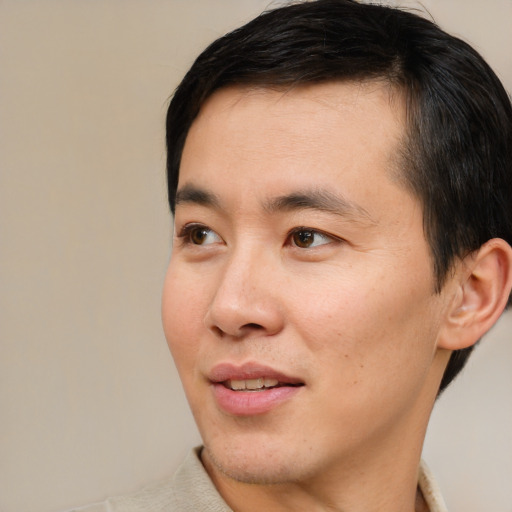 Joyful white young-adult male with short  black hair and brown eyes