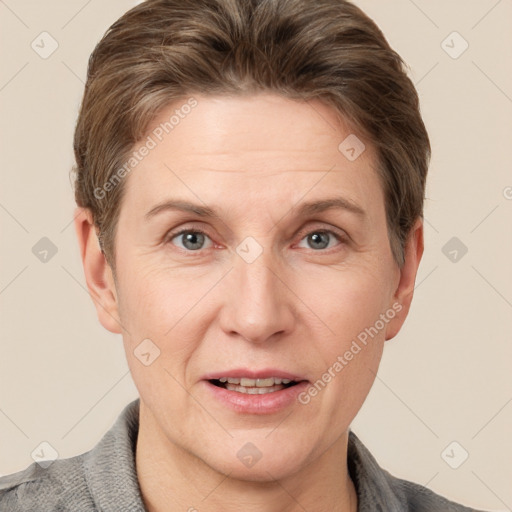 Joyful white adult female with short  brown hair and grey eyes