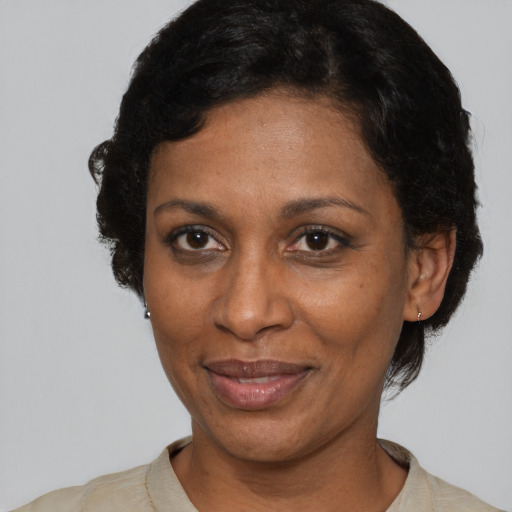 Joyful black adult female with short  brown hair and brown eyes