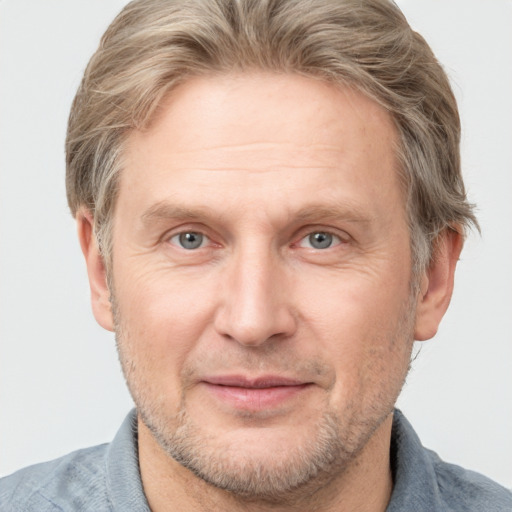 Joyful white adult male with short  brown hair and grey eyes