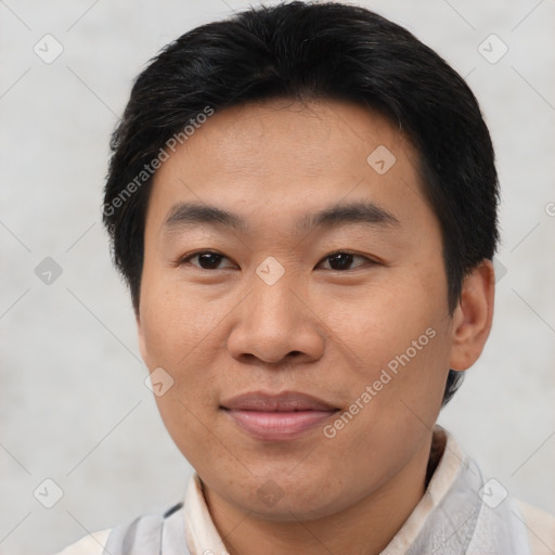 Joyful asian young-adult male with short  brown hair and brown eyes