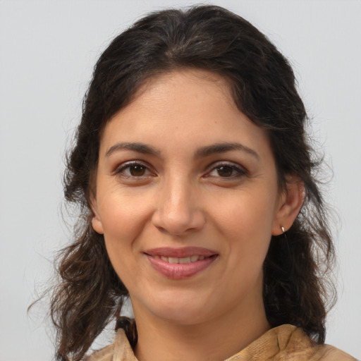 Joyful latino young-adult female with medium  brown hair and brown eyes