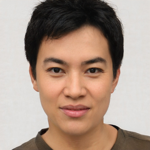 Joyful asian young-adult male with short  black hair and brown eyes