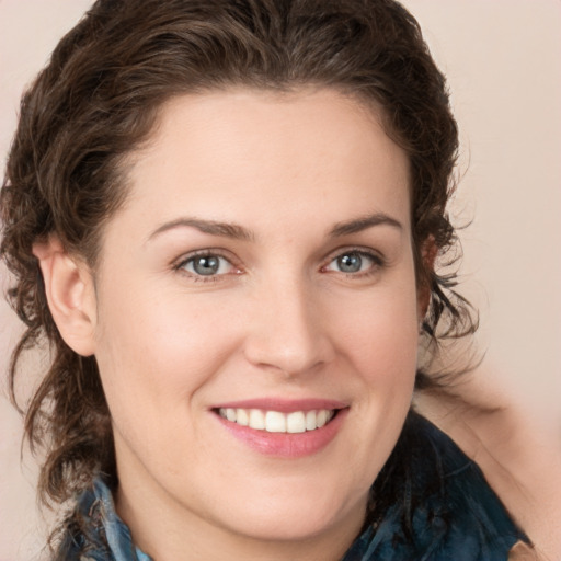 Joyful white young-adult female with medium  brown hair and green eyes