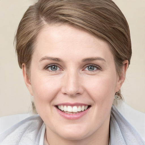 Joyful white young-adult female with medium  brown hair and blue eyes