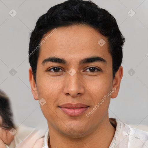 Joyful latino young-adult male with short  black hair and brown eyes