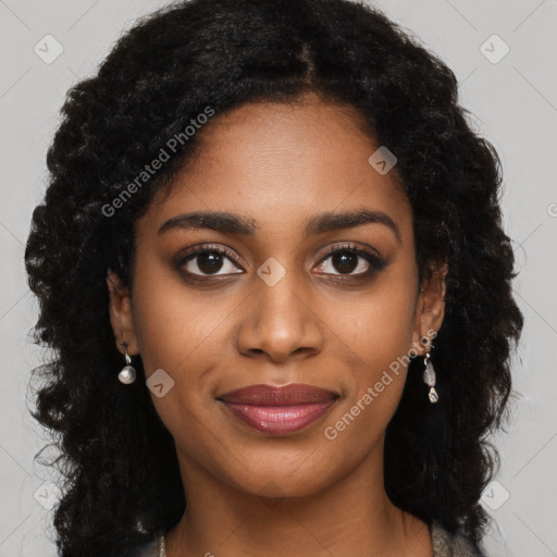 Joyful black young-adult female with long  black hair and brown eyes