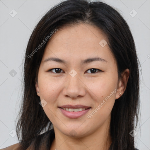 Joyful asian young-adult female with long  brown hair and brown eyes