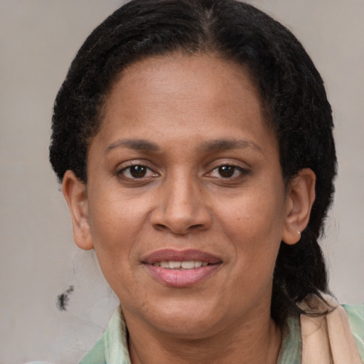 Joyful black adult female with short  brown hair and brown eyes