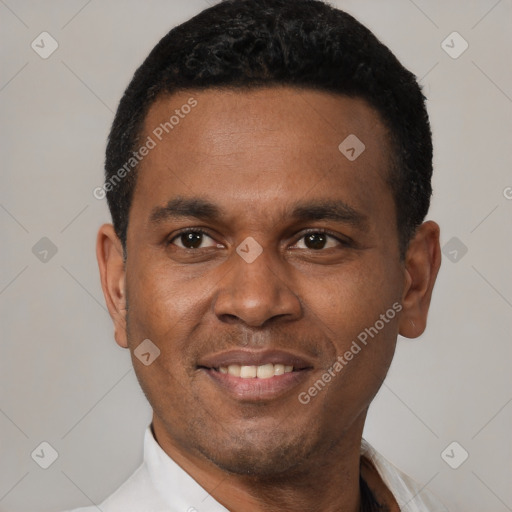 Joyful latino young-adult male with short  black hair and brown eyes