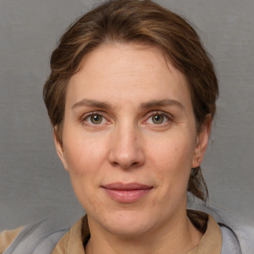 Joyful white adult female with short  brown hair and grey eyes