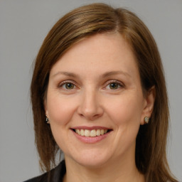 Joyful white adult female with medium  brown hair and grey eyes