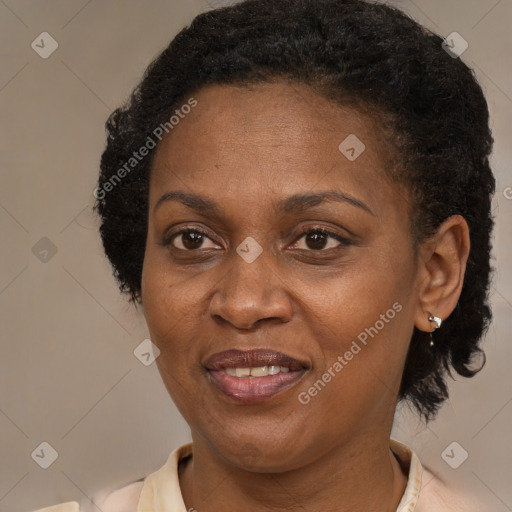 Joyful black adult female with medium  brown hair and brown eyes