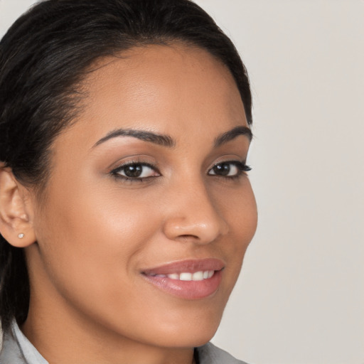 Joyful latino young-adult female with medium  brown hair and brown eyes