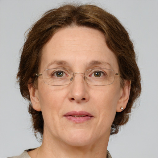 Joyful white adult female with medium  brown hair and green eyes