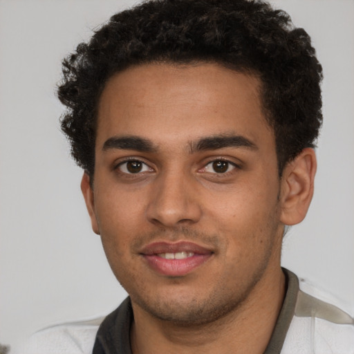 Joyful latino young-adult male with short  brown hair and brown eyes