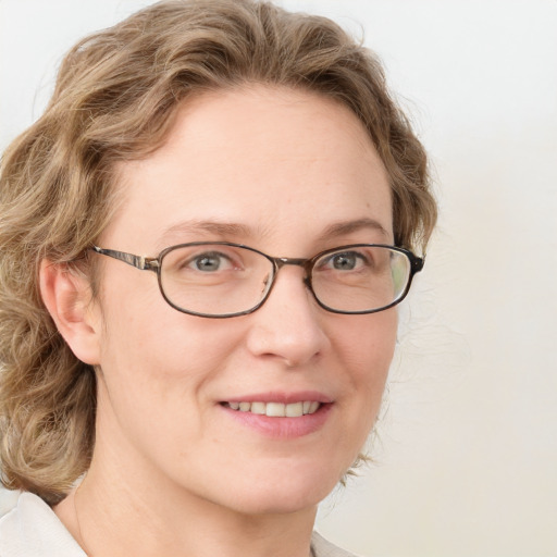 Joyful white adult female with medium  brown hair and blue eyes