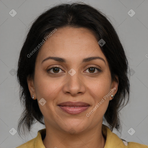 Joyful latino adult female with medium  brown hair and brown eyes