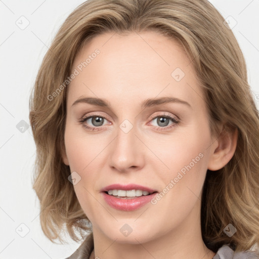 Joyful white young-adult female with long  brown hair and blue eyes