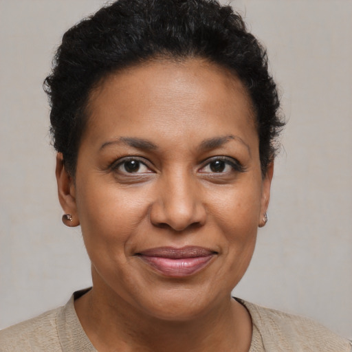 Joyful black adult female with short  brown hair and brown eyes