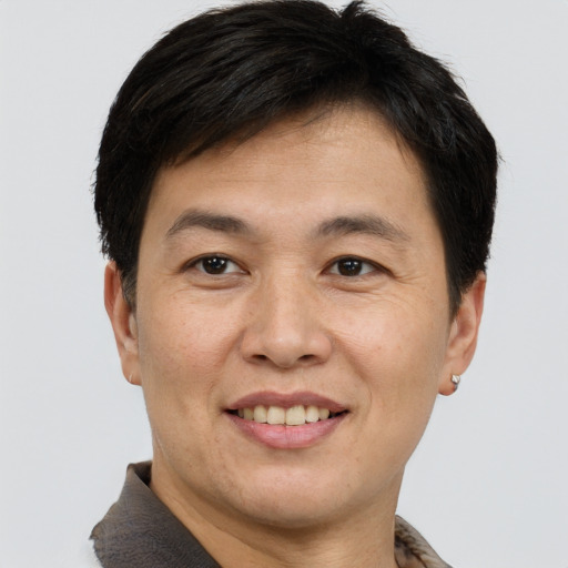 Joyful white adult male with short  brown hair and brown eyes