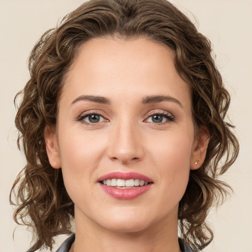 Joyful white young-adult female with medium  brown hair and green eyes