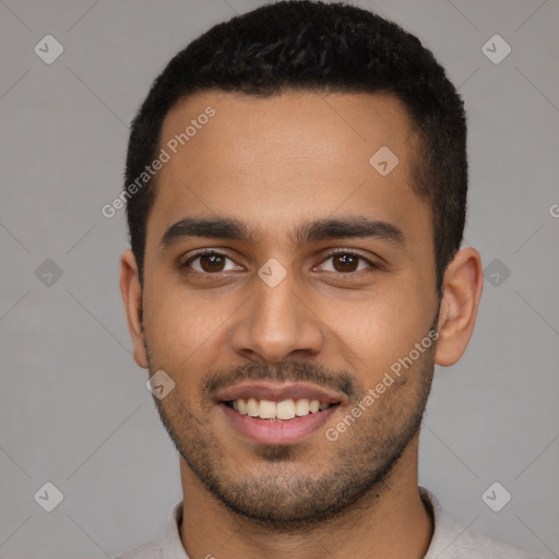 Joyful latino young-adult male with short  black hair and brown eyes