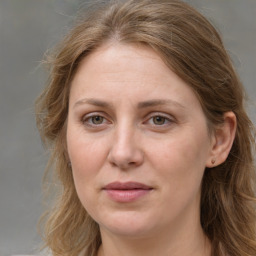 Joyful white adult female with long  brown hair and grey eyes