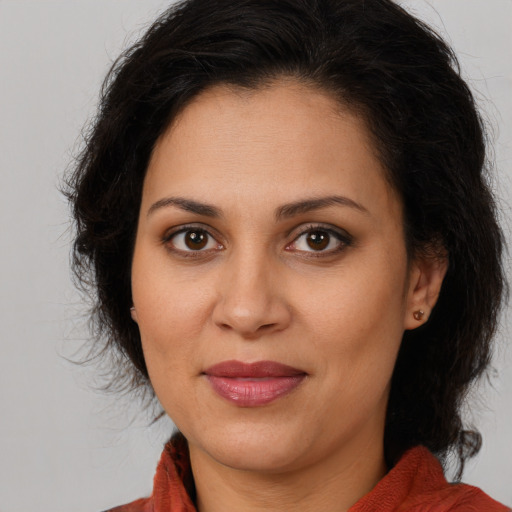 Joyful white adult female with medium  brown hair and brown eyes