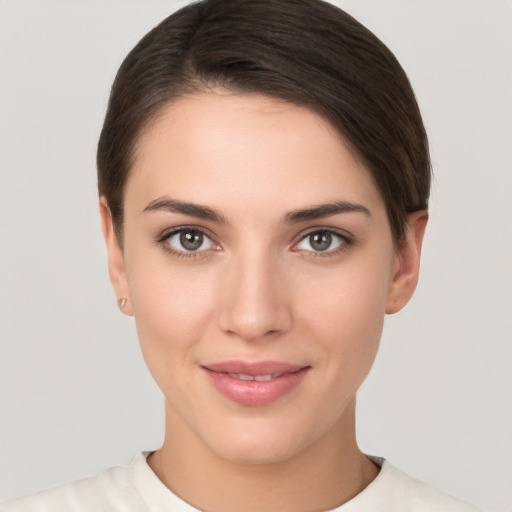 Joyful white young-adult female with short  brown hair and brown eyes