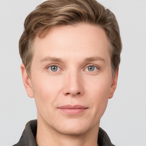 Joyful white young-adult male with short  brown hair and grey eyes