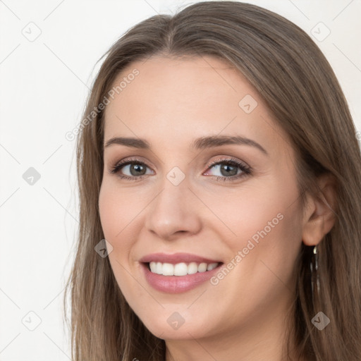 Joyful white young-adult female with long  brown hair and grey eyes