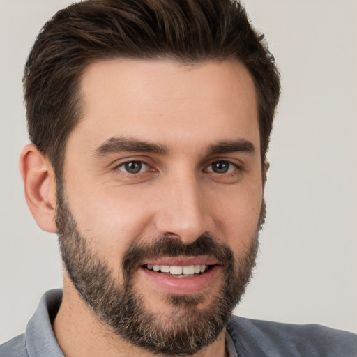 Joyful white young-adult male with short  brown hair and brown eyes