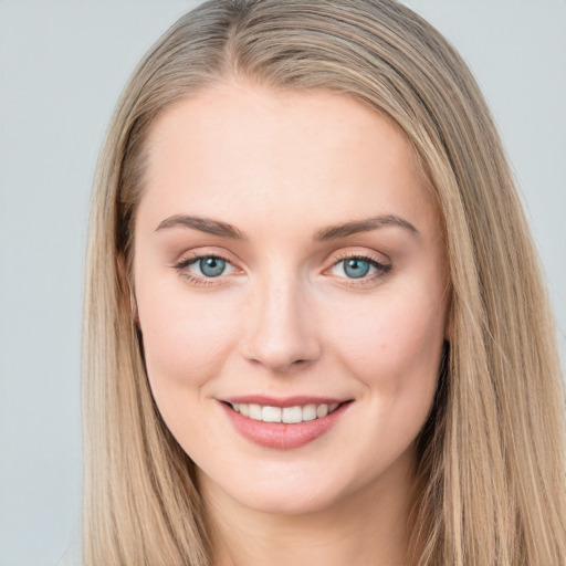 Joyful white young-adult female with long  brown hair and blue eyes