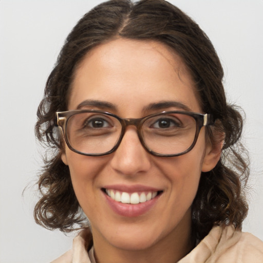 Joyful white adult female with medium  brown hair and brown eyes