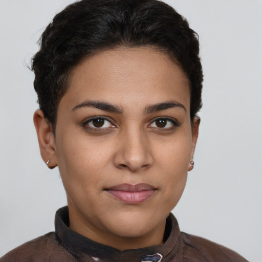 Joyful latino young-adult female with short  brown hair and brown eyes